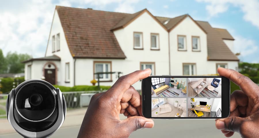 Man holding phone and checking footage from surveillance cameras