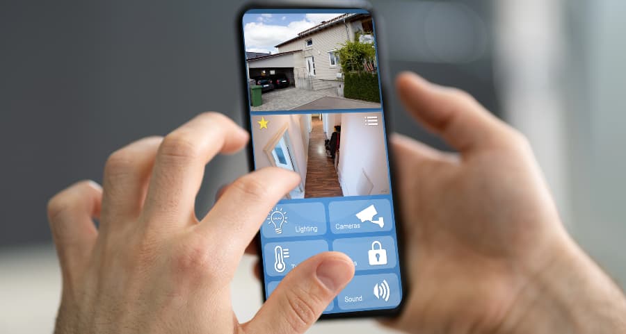 Homeowner looking at surveillance camera streams on a cell phone